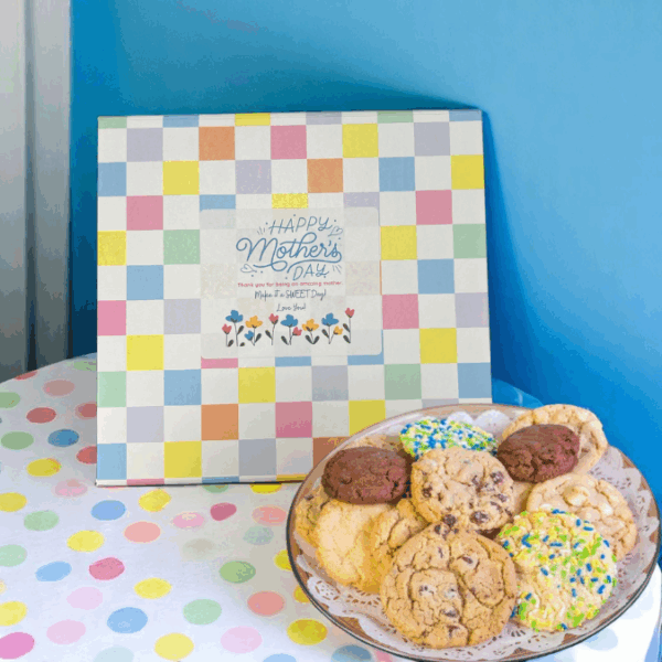 Mother's Day gift box and cookies on colorful tablecloth