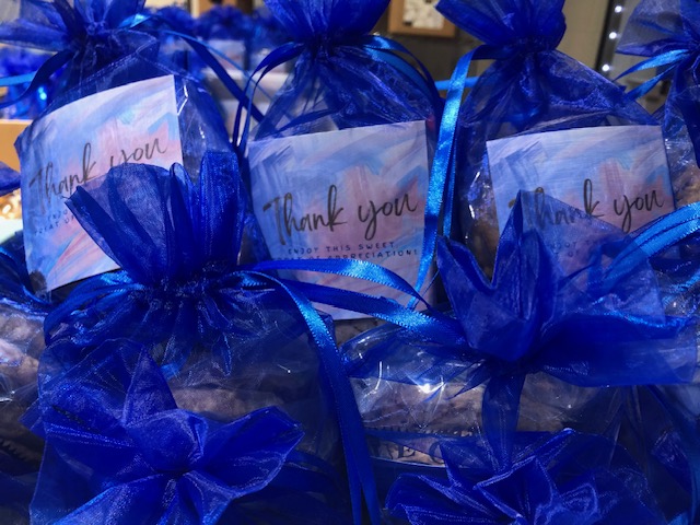 Blue gift bags with 'Thank you' cards attached