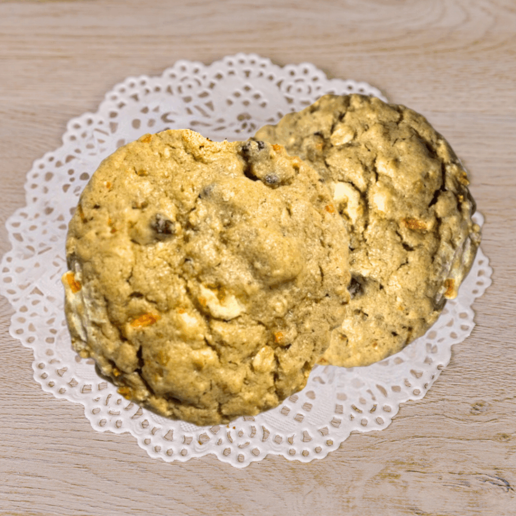 Two oatmeal cookies on lace paper doily