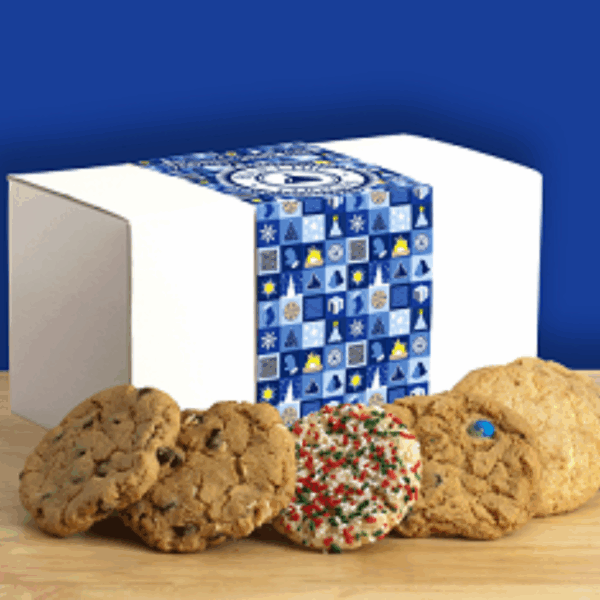 Assorted cookies in front of festive gift box.