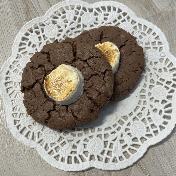 Chocolate cookies with marshmallows on lace doily.